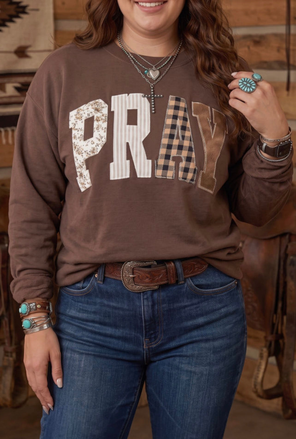 Pray Parchwork on a brown sweatshirt