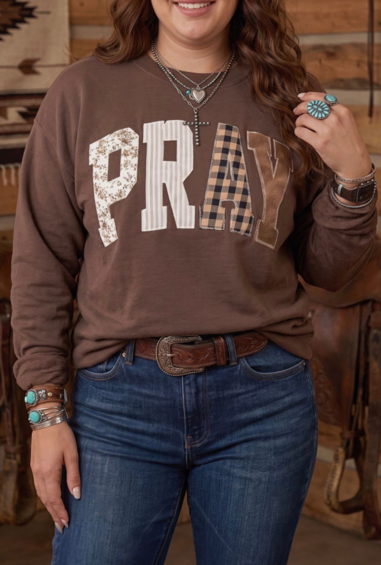 Pray Parchwork on a brown sweatshirt